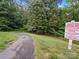 Serene paved walking path surrounded by lush greenery and mature trees, offering a peaceful outdoor experience at 4607 Silk Tree Ln, Rock Hill, SC 29732