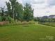 Expansive backyard with lush grass and a view of the surrounding neighborhood at 5000 Britannia Blvd, Waxhaw, NC 28173