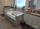 Luxurious bathroom featuring a large soaking tub with tiled surround and dual vanities at 5000 Britannia Blvd, Waxhaw, NC 28173