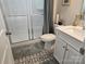 Charming bathroom featuring a glass shower, toilet, and patterned tile floor at 5000 Britannia Blvd, Waxhaw, NC 28173
