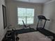 Exercise room with treadmill, weight bench, and ample space for a home gym at 5000 Britannia Blvd, Waxhaw, NC 28173