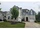 Beautiful two-story home featuring stone accents, a well-manicured lawn, and a two-car garage at 5000 Britannia Blvd, Waxhaw, NC 28173