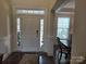Inviting foyer featuring a hardwood floor, sidelight windows, and a view into the dining area at 5000 Britannia Blvd, Waxhaw, NC 28173