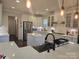 Modern kitchen with stainless steel appliances, white cabinets, and a large central island at 5000 Britannia Blvd, Waxhaw, NC 28173