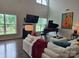 Bright living room with high ceilings, large windows, grand piano, and fireplace at 5000 Britannia Blvd, Waxhaw, NC 28173