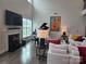 Elegant living room featuring a fireplace, grand piano, and comfortable seating at 5000 Britannia Blvd, Waxhaw, NC 28173