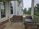 Relaxing screened-in porch with wicker furniture, ideal for outdoor enjoyment at 5000 Britannia Blvd, Waxhaw, NC 28173