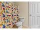 Bathroom with a colorful shower curtain and standard white toilet at 5111 Elementary View Dr, Charlotte, NC 28269
