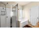 Bathroom featuring a shower with glass door and a separate soaking tub beneath a window at 5111 Elementary View Dr, Charlotte, NC 28269