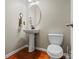Bathroom with pedestal sink and toilet; features classic design and clean lines at 5111 Elementary View Dr, Charlotte, NC 28269