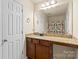 Bathroom with a granite vanity, mirror, and a colorful shower curtain at 5111 Elementary View Dr, Charlotte, NC 28269