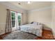 Spacious bedroom with hardwood floors, large windows, and decorative curtains allows for plenty of natural light at 5111 Elementary View Dr, Charlotte, NC 28269
