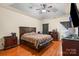 Spacious bedroom with a tray ceiling and hardwood floors offers a relaxing retreat at 5111 Elementary View Dr, Charlotte, NC 28269