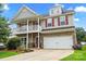 Inviting two-story home featuring a charming front porch, stone accents, and a well-manicured lawn at 5111 Elementary View Dr, Charlotte, NC 28269