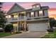 Inviting two-story home featuring a charming front porch, stone accents, and a well-manicured lawn at 5111 Elementary View Dr, Charlotte, NC 28269