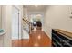 Bright hallway with wood floors leading to a cozy living area, stairs and front door at 5111 Elementary View Dr, Charlotte, NC 28269