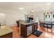 Well-lit open kitchen with a granite countertop island, a sink, and stainless steel appliances at 5111 Elementary View Dr, Charlotte, NC 28269