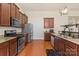 Well-equipped kitchen with stainless steel appliances, granite countertops, wooden cabinets, and an open layout at 5111 Elementary View Dr, Charlotte, NC 28269