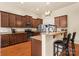 Charming kitchen featuring wood cabinets, granite countertops, stainless steel appliances, and breakfast bar at 5111 Elementary View Dr, Charlotte, NC 28269