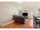 Bright, open living room featuring hardwood floors, reclining sofas, and a cozy ambiance at 5111 Elementary View Dr, Charlotte, NC 28269