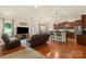 Bright, open living room featuring hardwood floors, reclining sofas, and a cozy ambiance at 5111 Elementary View Dr, Charlotte, NC 28269