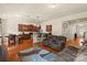 Open-concept living room and kitchen with wood floors and lots of seating at 5111 Elementary View Dr, Charlotte, NC 28269