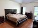 Main bedroom suite featuring wood flooring, a tray ceiling, and a luxurious dresser at 5111 Elementary View Dr, Charlotte, NC 28269