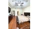 Spacious main bedroom suite with wood flooring and a tray ceiling with fan at 5111 Elementary View Dr, Charlotte, NC 28269