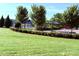 Community park featuring manicured green lawn, mature trees, and picnic benches at 5111 Elementary View Dr, Charlotte, NC 28269