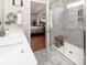 This bathroom features a glass enclosed shower, white cabinets, and neutral walls at 512 Rosebush Ln, Clover, SC 29710