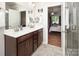 This bathroom features double sinks, dark cabinetry, and access to the bedroom at 512 Rosebush Ln, Clover, SC 29710