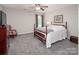 Bedroom features neutral walls, soft gray carpet, and a traditional four-poster bed at 512 Rosebush Ln, Clover, SC 29710