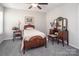 This bedroom features soft gray carpet, neutral walls, and wood furniture at 512 Rosebush Ln, Clover, SC 29710