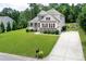 Spacious home with a long driveway and a large, lush green lawn surrounded by mature trees at 512 Rosebush Ln, Clover, SC 29710