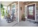 Inviting front porch with rocking chairs, stone accents, and a decorative front door at 512 Rosebush Ln, Clover, SC 29710