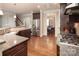 Spacious kitchen with wood floors, stainless steel refrigerator, granite counters, and an open layout at 512 Rosebush Ln, Clover, SC 29710