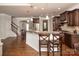 Bright, open kitchen with wood floors, bar seating, stainless steel appliances, and access to dining area at 512 Rosebush Ln, Clover, SC 29710