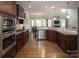 Modern kitchen with stainless steel appliances, granite countertops, and dark wood cabinetry at 512 Rosebush Ln, Clover, SC 29710