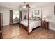 Spacious main bedroom with hardwood floors, a four-poster bed, and sitting area at 512 Rosebush Ln, Clover, SC 29710
