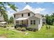 Lovely rear home view featuring deck, awning, well-maintained landscaping, and lush green lawn at 512 Rosebush Ln, Clover, SC 29710