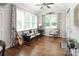 Relaxing sun room with ample natural light, wood floors, and comfortable seating at 512 Rosebush Ln, Clover, SC 29710