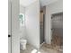 Bright bathroom with glass enclosed shower, toilet, and view into closet at 5526 Brookwood Ln, Hickory, NC 28602