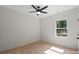 Clean bedroom with ceiling fan, window, and hardwood floors offering a comfortable retreat at 5526 Brookwood Ln, Hickory, NC 28602