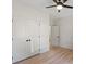 Bright bedroom with a ceiling fan, closet, hardwood floors, and white trim detail at 5526 Brookwood Ln, Hickory, NC 28602