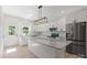 Modern kitchen featuring a large island with countertop seating, stainless steel appliances and white cabinetry at 5526 Brookwood Ln, Hickory, NC 28602