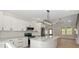 Bright kitchen with a marble island, stainless steel appliances, modern lighting, and lots of cabinets at 5526 Brookwood Ln, Hickory, NC 28602