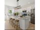 Bright kitchen featuring a marble island, stainless steel appliances, and modern light fixtures at 5526 Brookwood Ln, Hickory, NC 28602