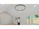 Bright open-concept room with high ceilings, modern light fixture, and large windows at 5526 Brookwood Ln, Hickory, NC 28602