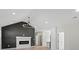Modern living room featuring a white fireplace, dark accent wall, and updated light fixture at 5526 Brookwood Ln, Hickory, NC 28602