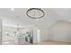 Open floor plan with a modern kitchen island, stainless steel appliances, and elegant lighting at 5526 Brookwood Ln, Hickory, NC 28602